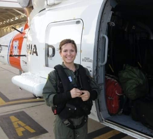 Megan Godsey next to a helicopter in the Coast Guard