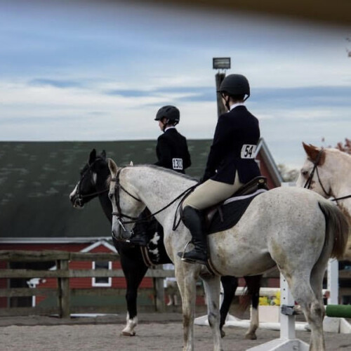 two members of the equestrian team on horseback