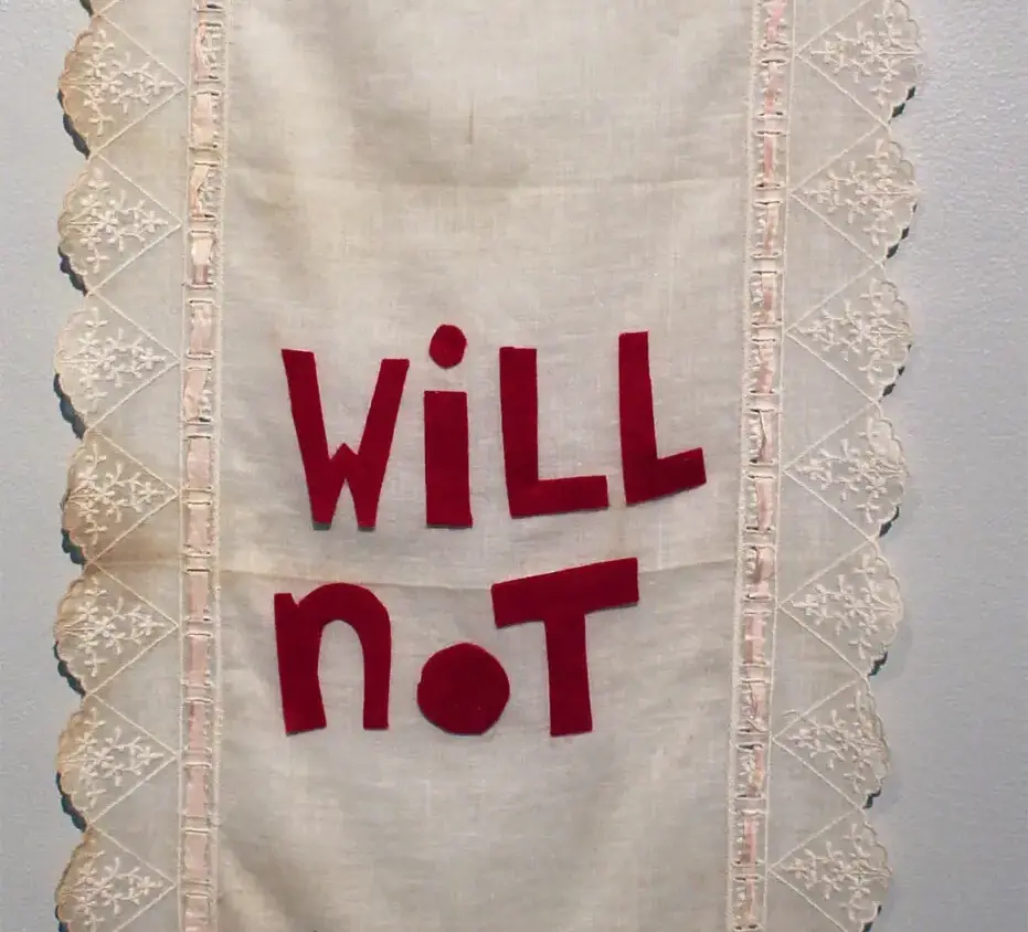 a large vintage cloth embellished with the words I will not break in red felt letters