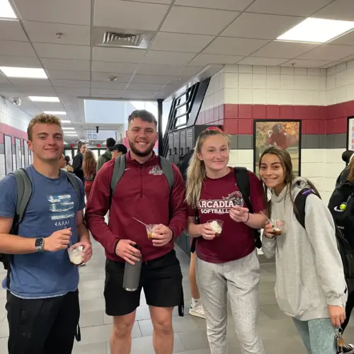 Students smiling and posing to the camera in the Kuch Center