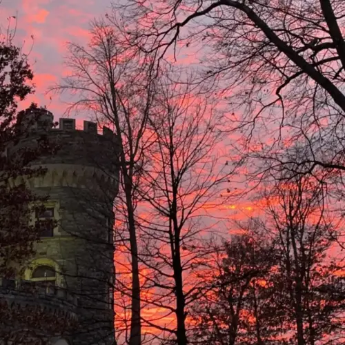 A pink and purple sky behind Grey Towers Castle