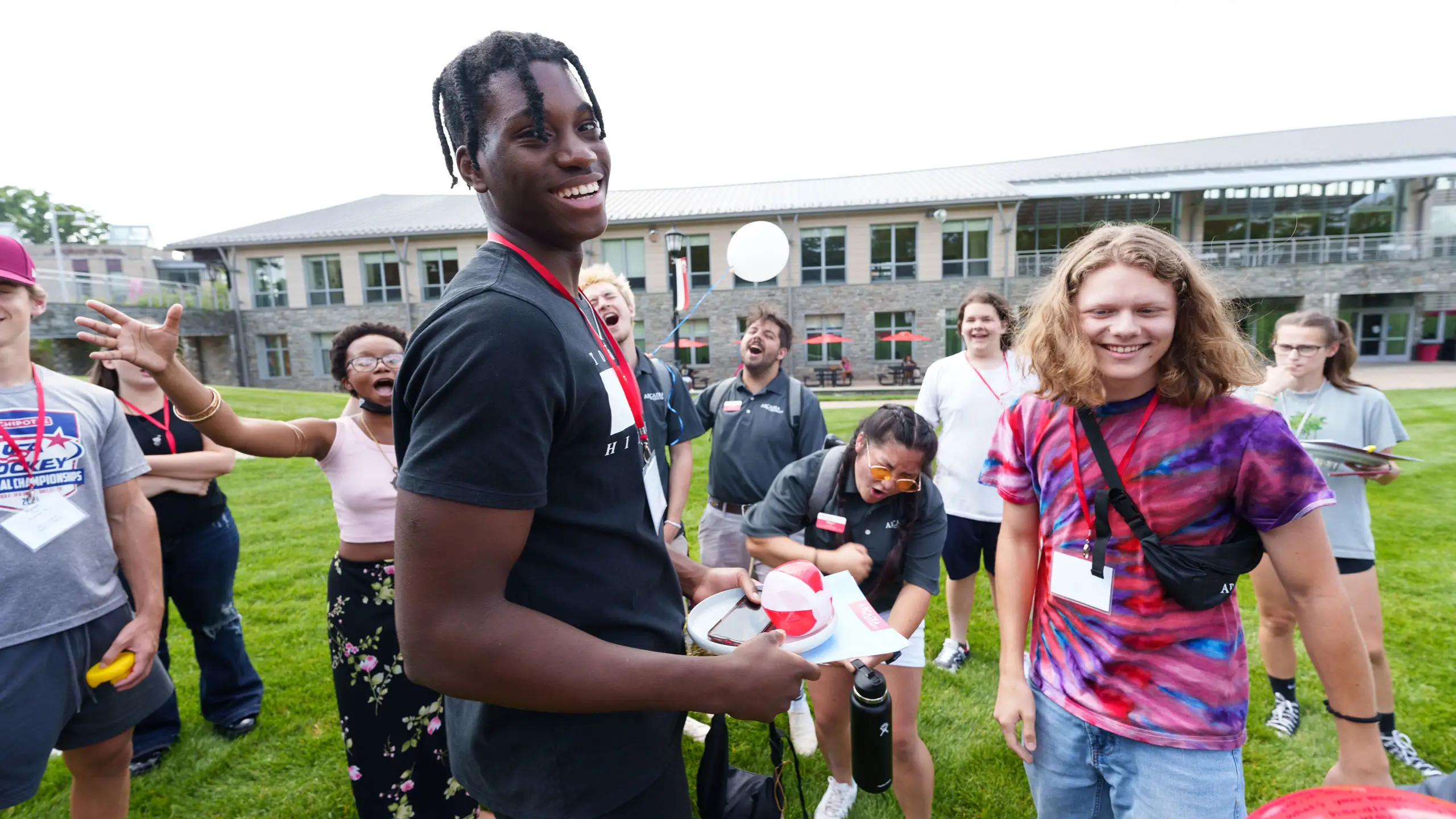 Group of students cheering on Haber Green during orientation