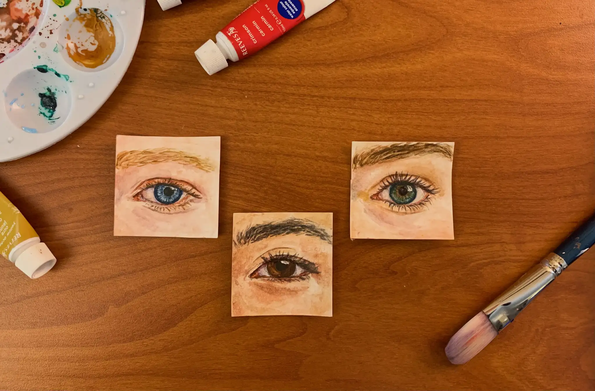 Watercolor paintings of three human eyes