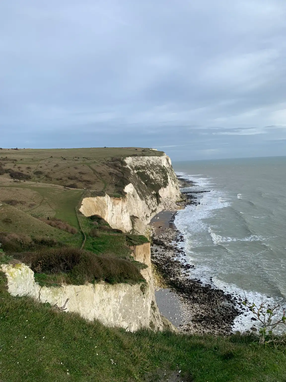 A green cliff overlooking a body of water