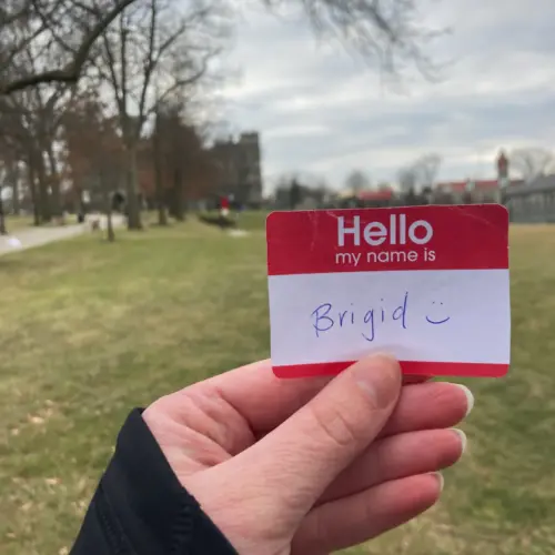 A name tag held in front of Haber Green that says "Hello my name is Brigid"