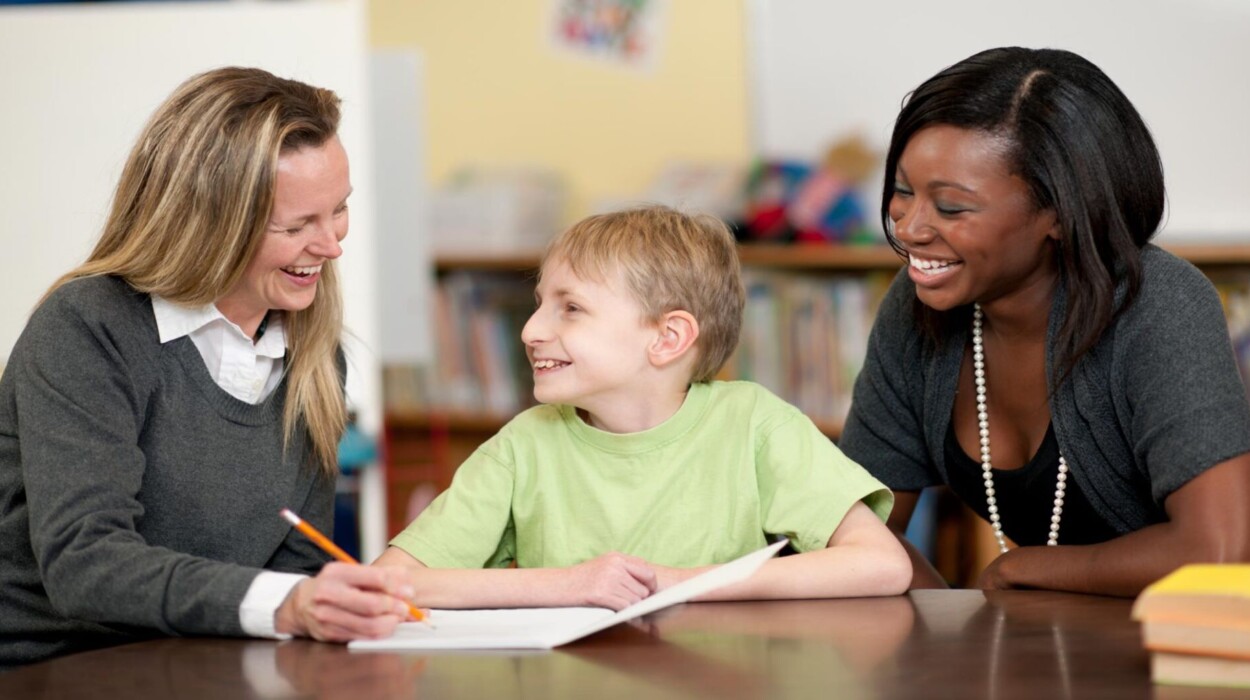 Special Education teachers collaborate with student in a classroom setting