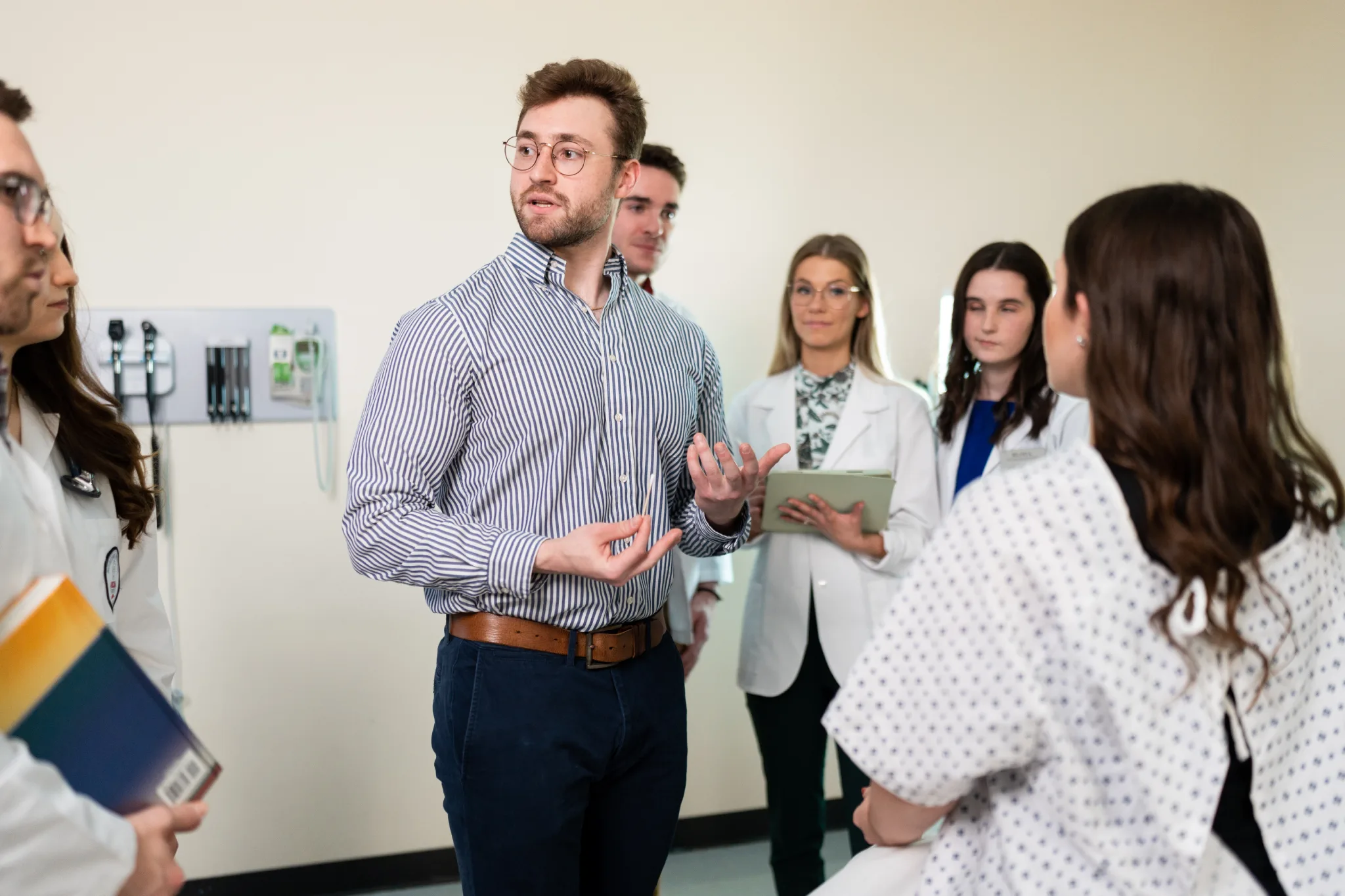 PA students and professors in a group setting discussing the patient's needs