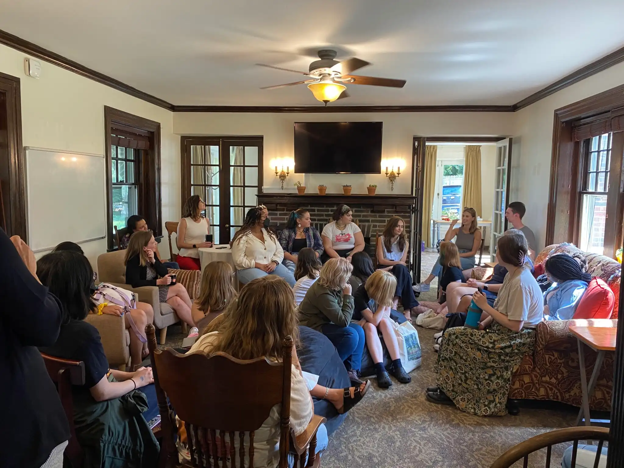 Large group of students sitting inside the Civic and Global Engagement House.