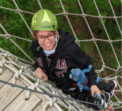 A student climbing a rope