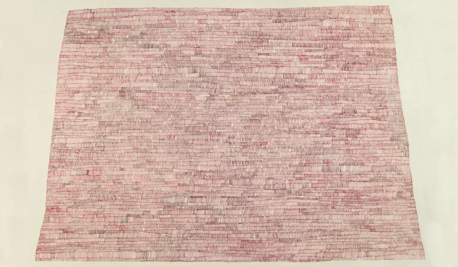 a drawing in red ink on paper that resembles a butte