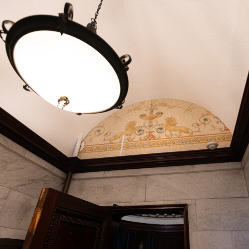 A mural uncovered beneath a drop ceiling inside a women's restroom in the Castle