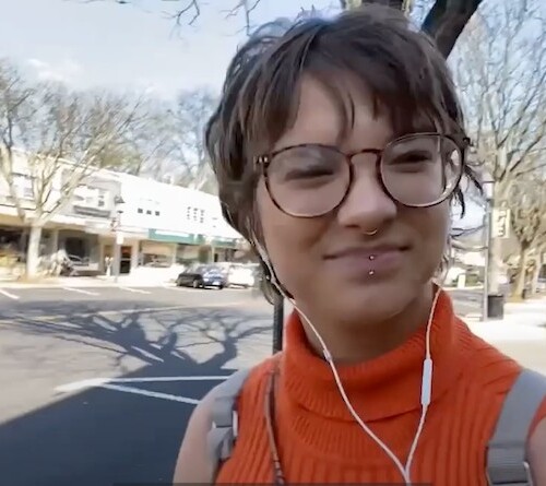 Danita smiling and walking through the Keswick Village.