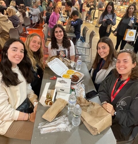 Five students sitting at a table in Reading Terminal Market.