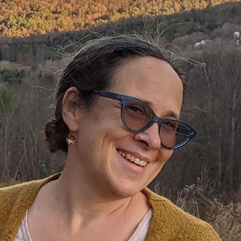 Ellen Skilton Professor, School of Education, and Faculty Director of Center for Teaching, Learning, and Learning smiles with mountains in the background.