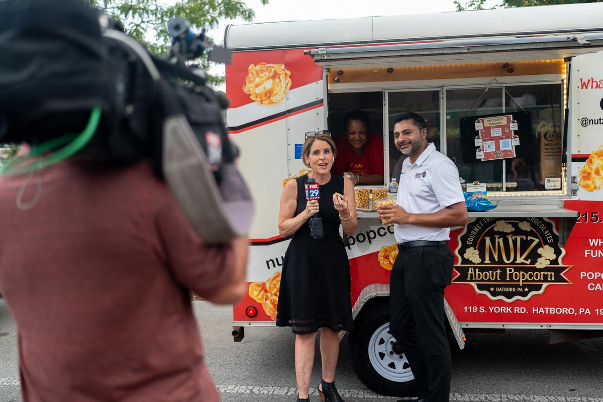 Kathy Orr interviews president Ajay Nair at the Downtown Glenside Food Truck Festival