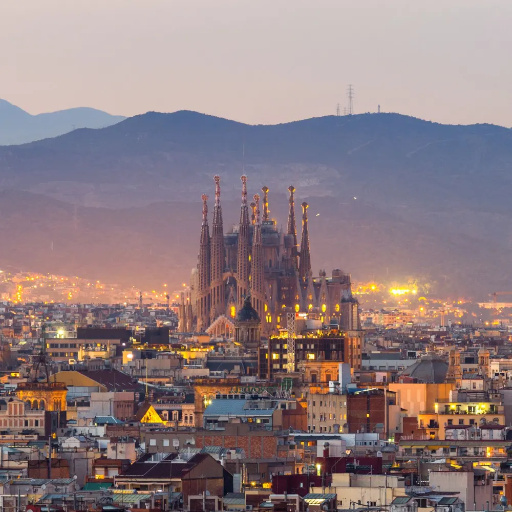 aerial view of Barcelona city with bioldings and mountains