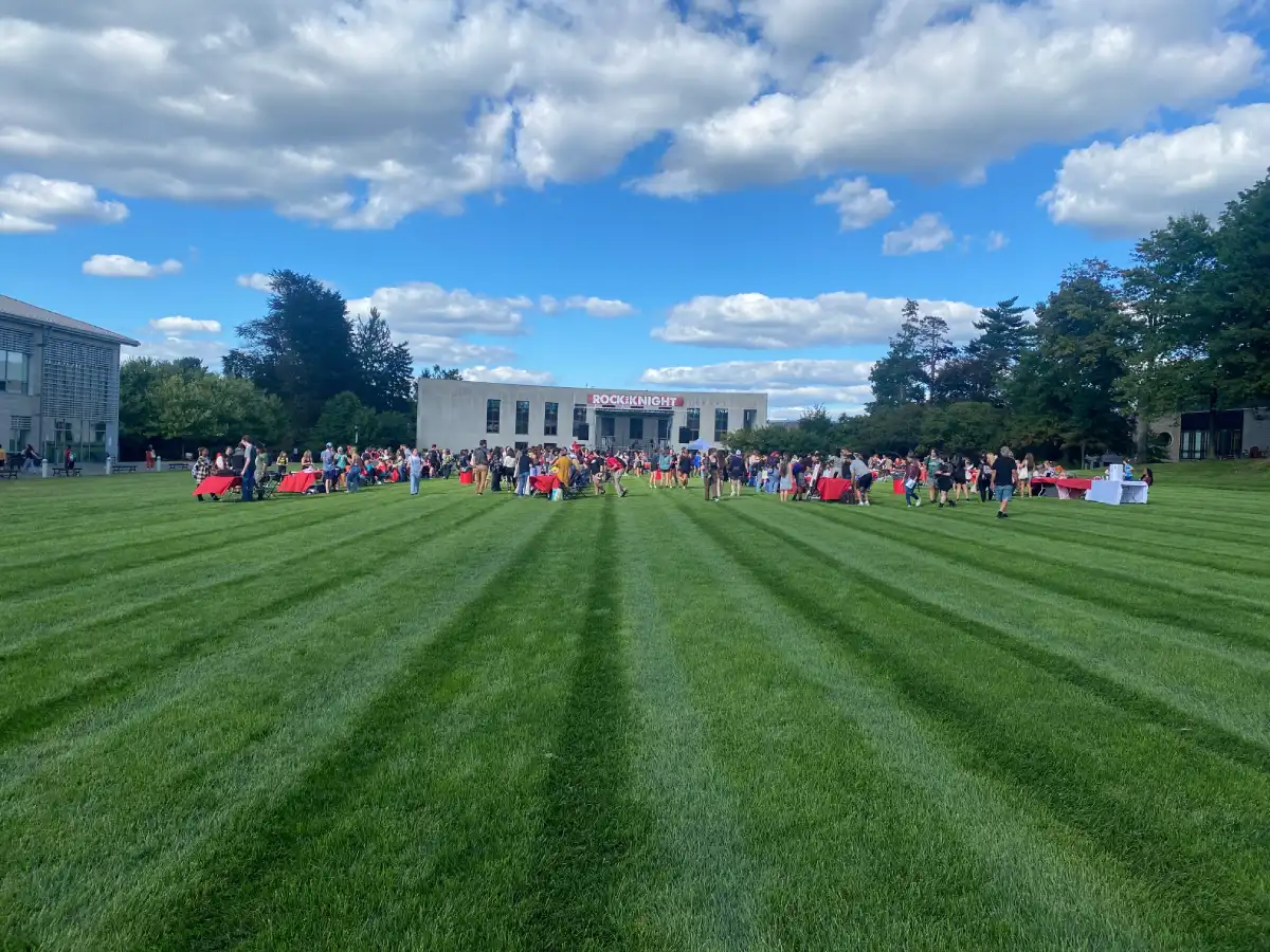 Haber Green with tables, chairs, and lots of students.