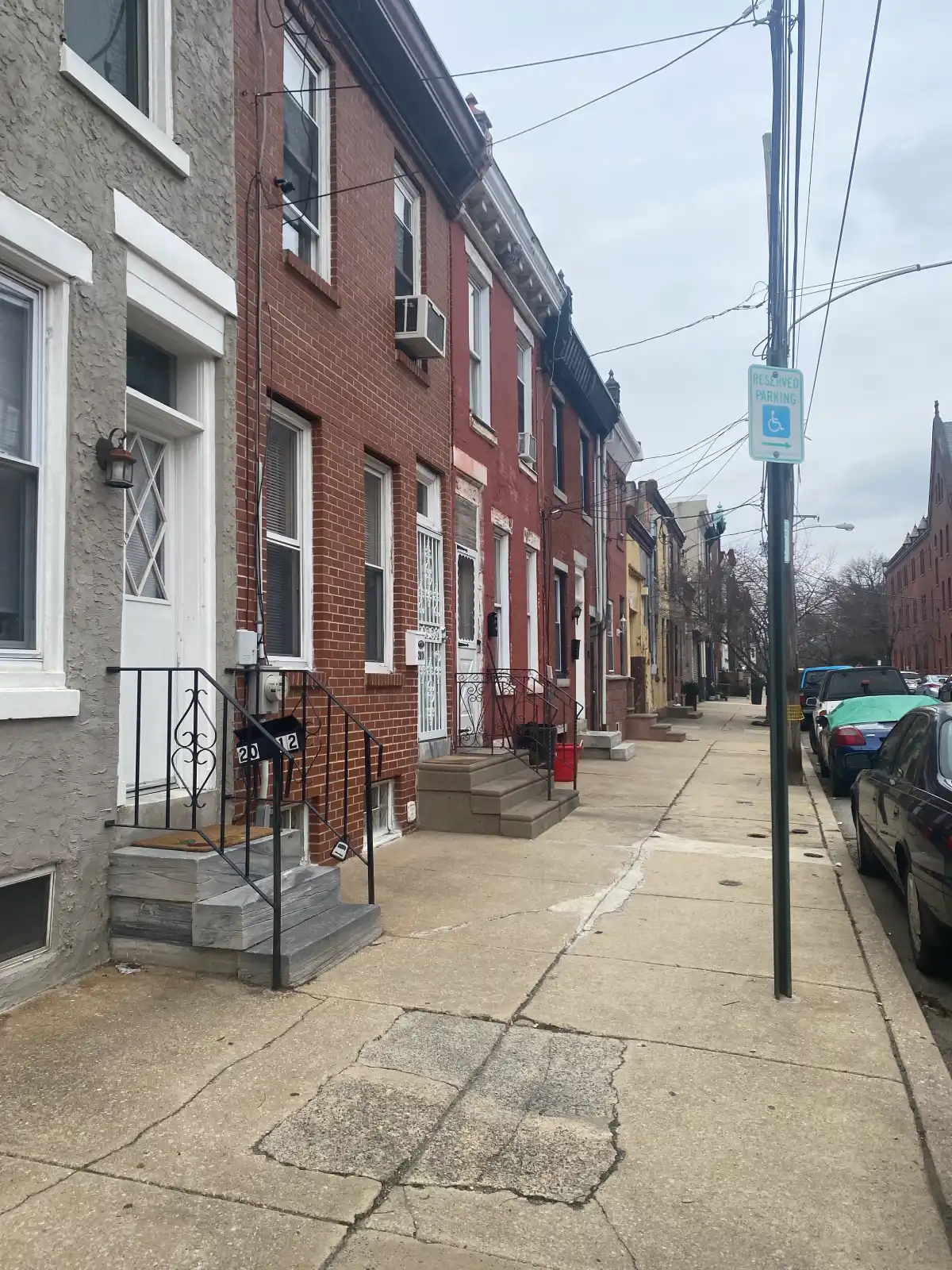 A photo of a sidewalk in Kensignton with buildings to the left.