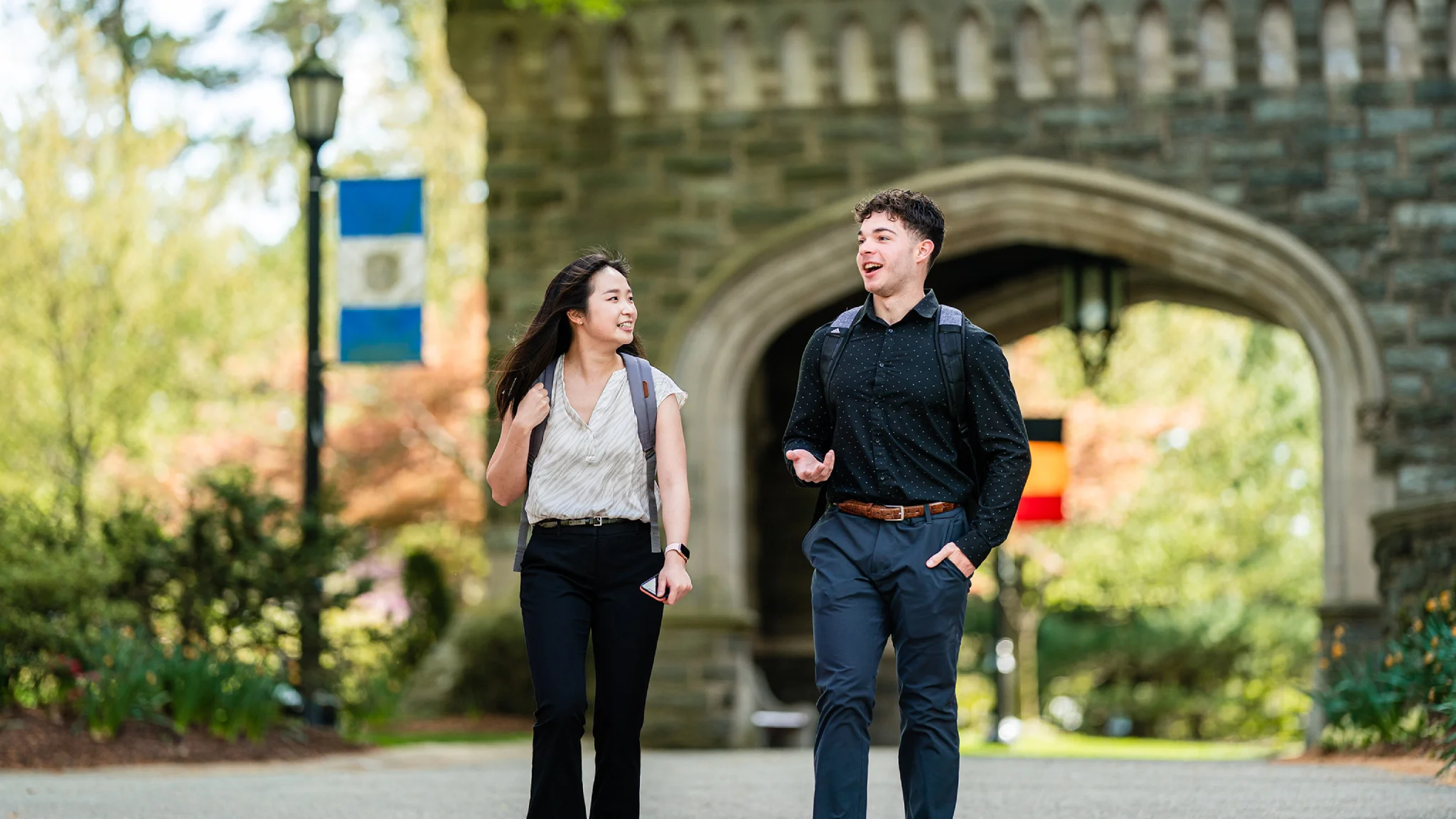 Spring photoshoot of two students walking.