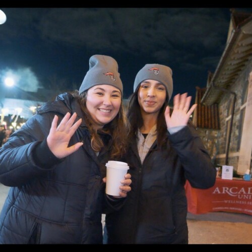Two people wearing Arcadia hats at Get Lit event