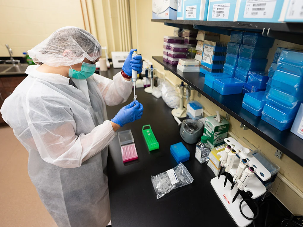 A Forensics Program student conducts a DNA test in an Arcadia lab.