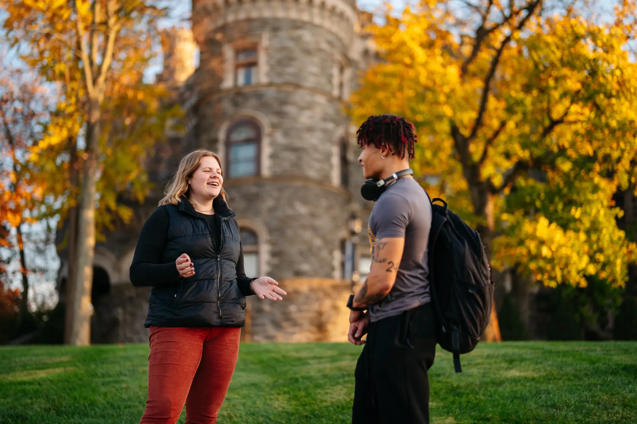 Students talking on campus with the Castle behind them