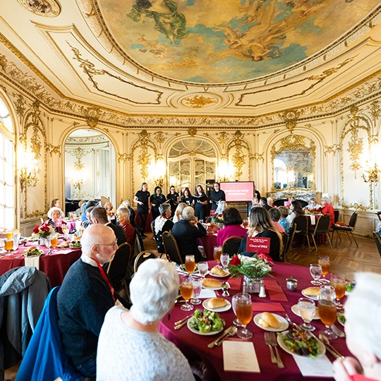 Alumni meet at a banquet in the castle.