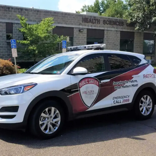 An Arcadia Public Safety vehicle parked in front of health services on campus.