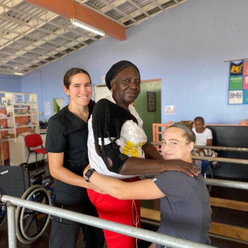 Sarah and Tate helping a patient.