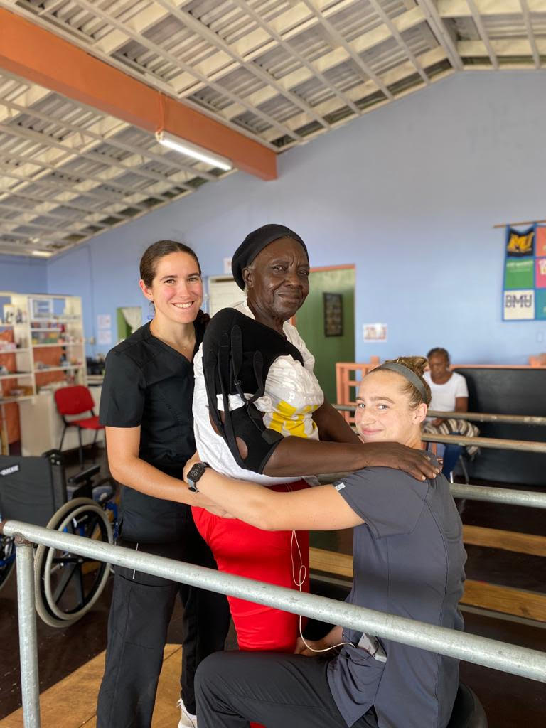 Sarah and Tate helping a patient.