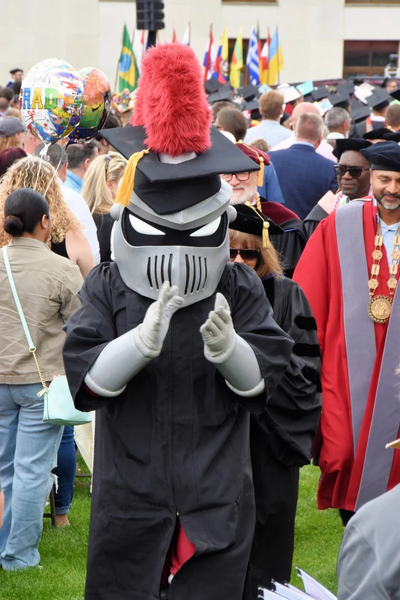 Archie the Knight clapping after graduation