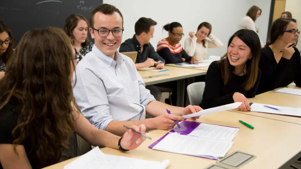 Students in class learning and laughing with each other.