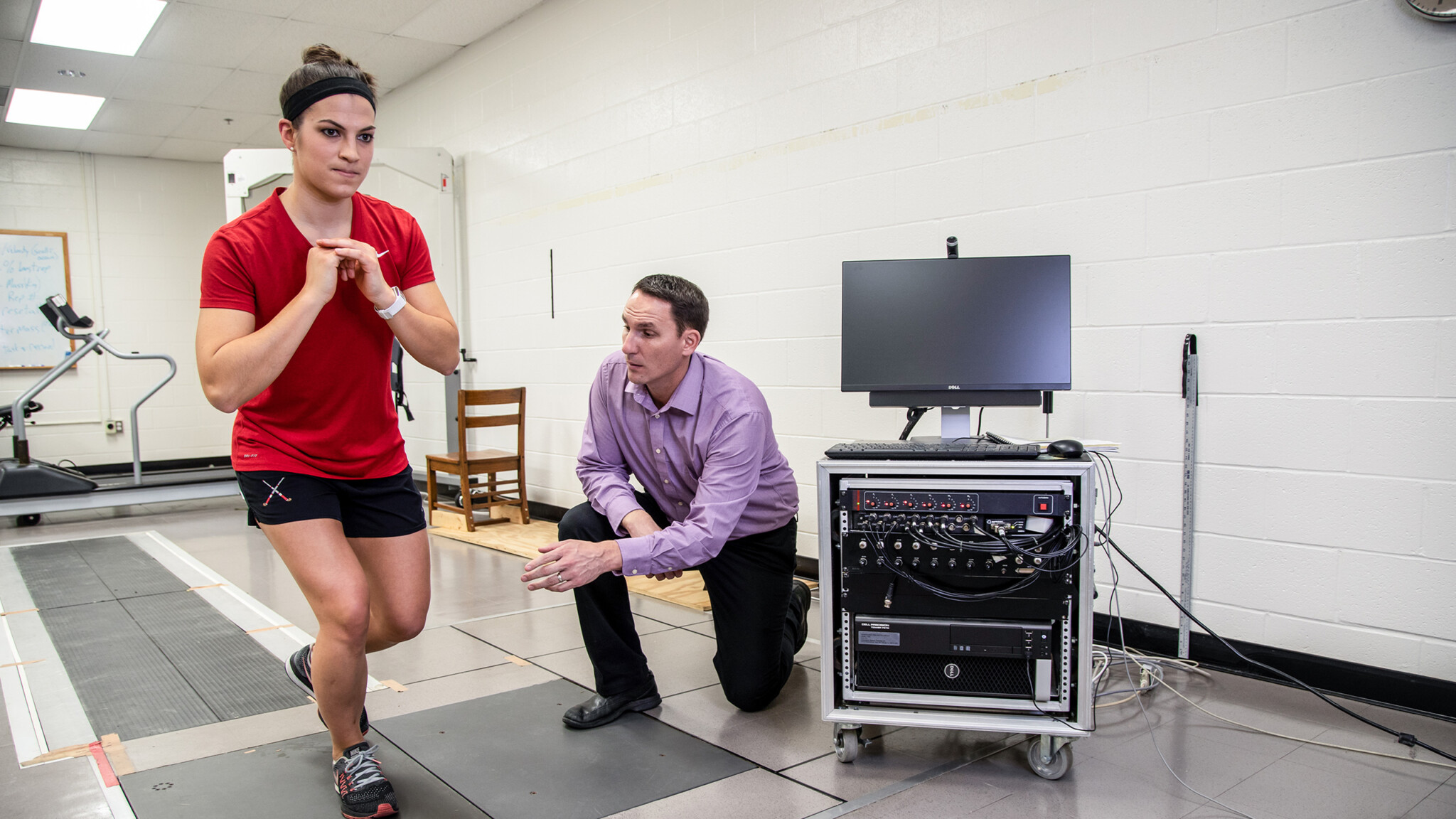 A student and faculty member work on a training session for physical therapy.