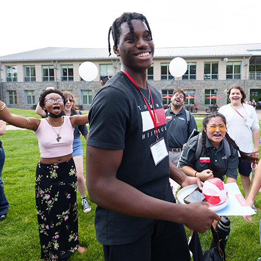 Students cheer during an orientation event on campus.