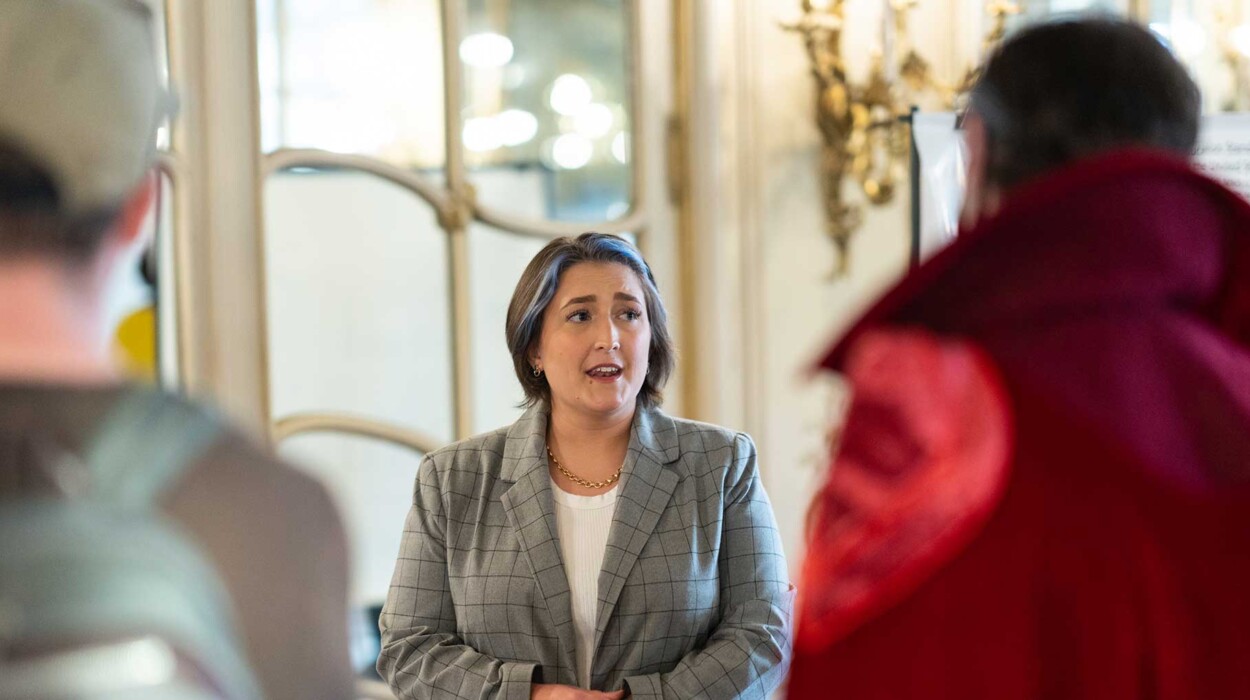 A speaker at a conference in the Mirror Room