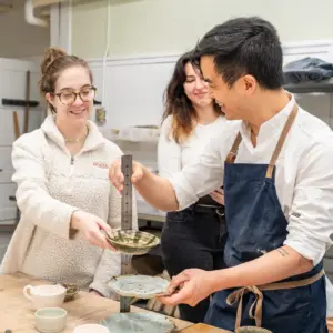 Chef Rhee working with ceramics students.