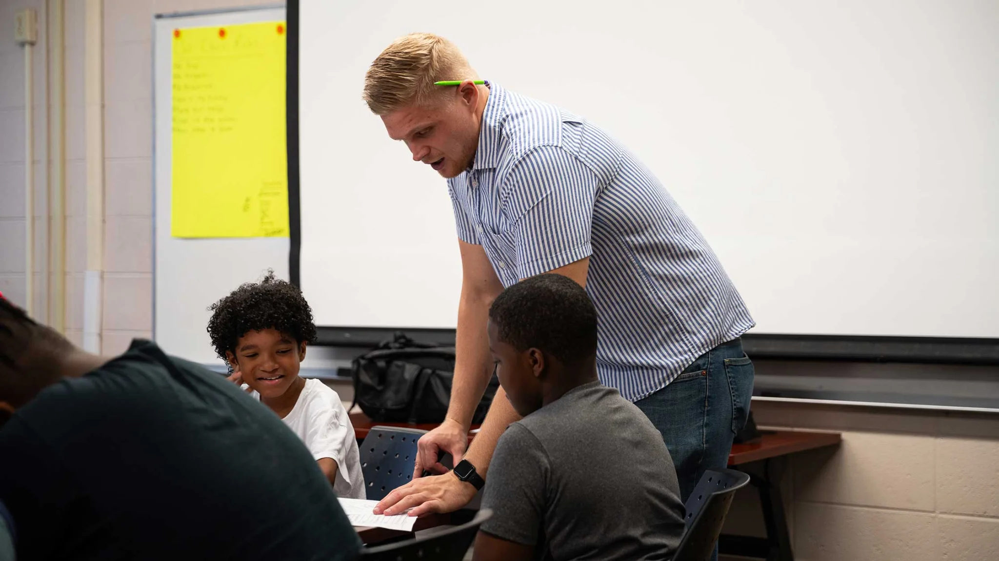 A person teaching to kids