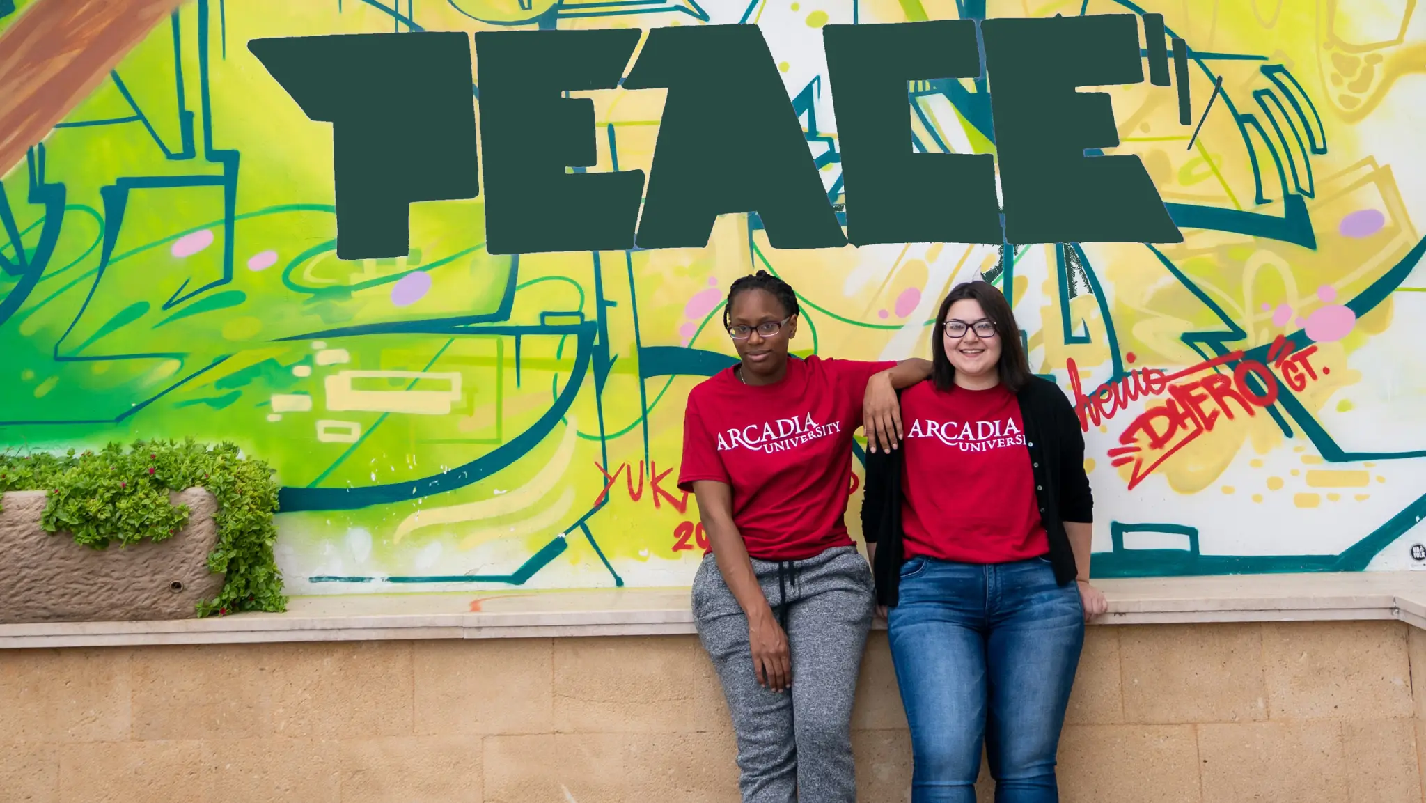 IPCR students stnd in front of an IPCR sign.