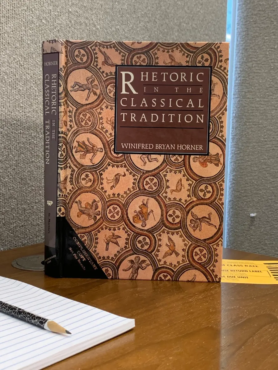 "Rhetoric in the Classical Tradition" by Winifred Bryan Horner standing on Justin's desk.