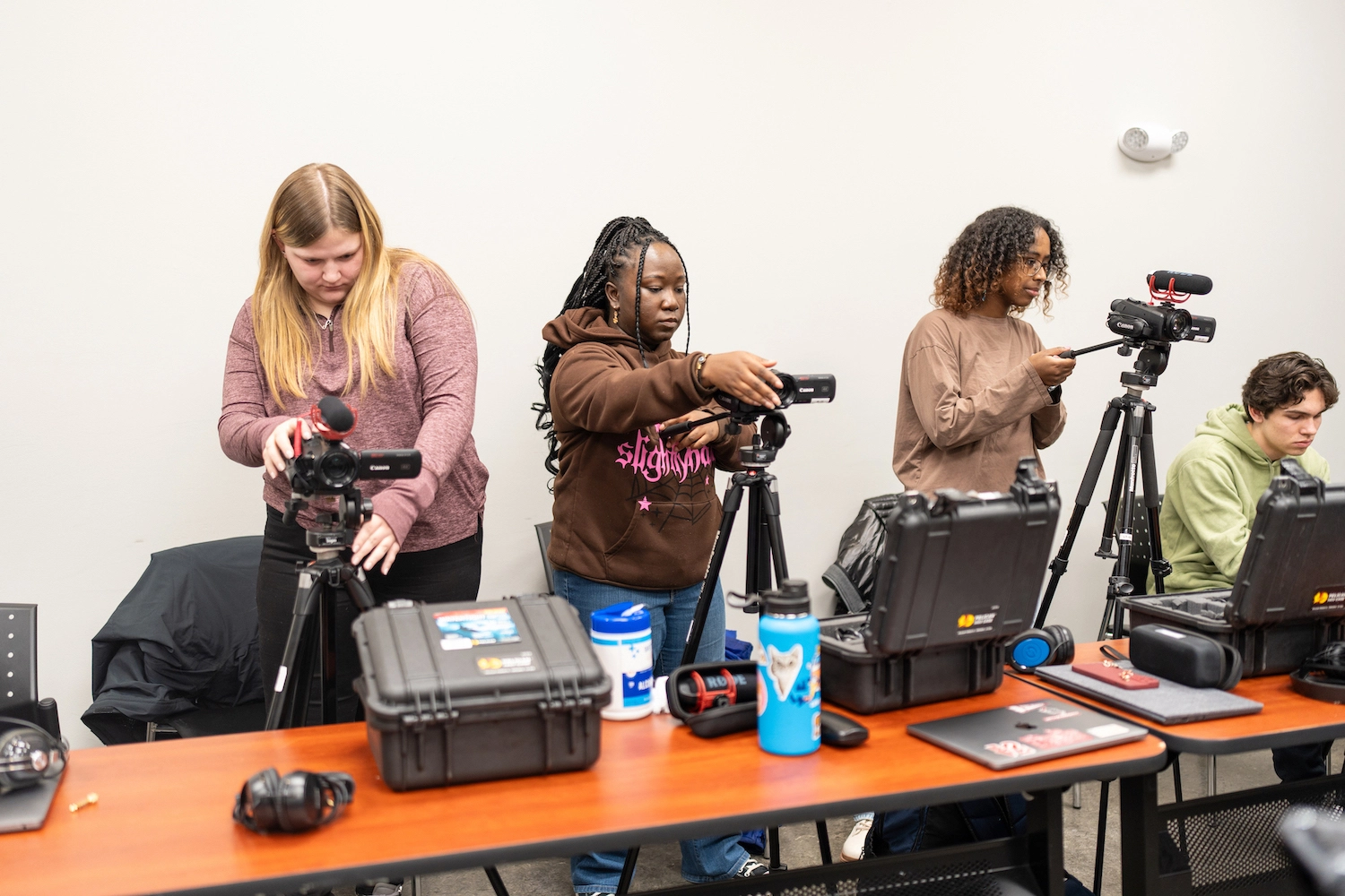Arcadia students in media and communications prepare their cameras for use.