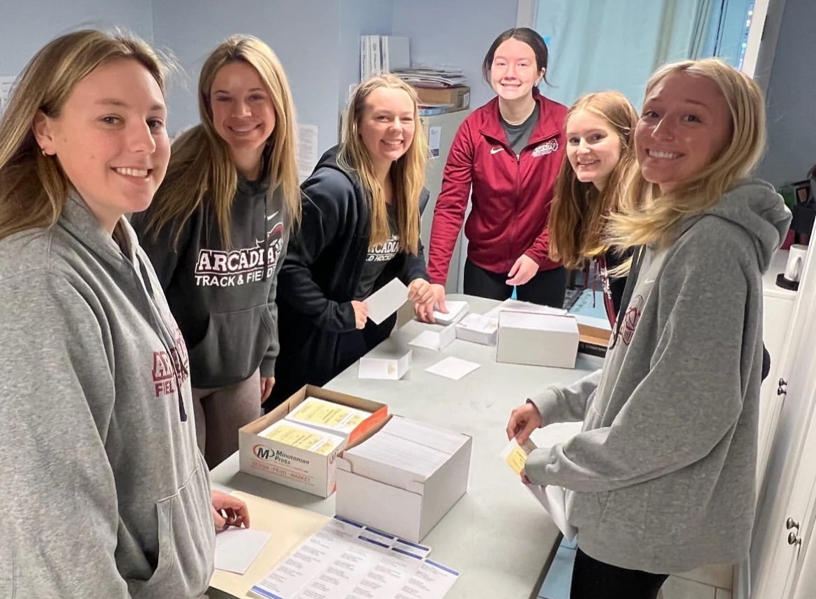 Members of the field hockey team organize donations for families at Cradle of Hope