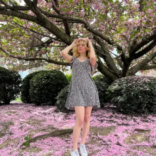 Zara under a blossoming tree.