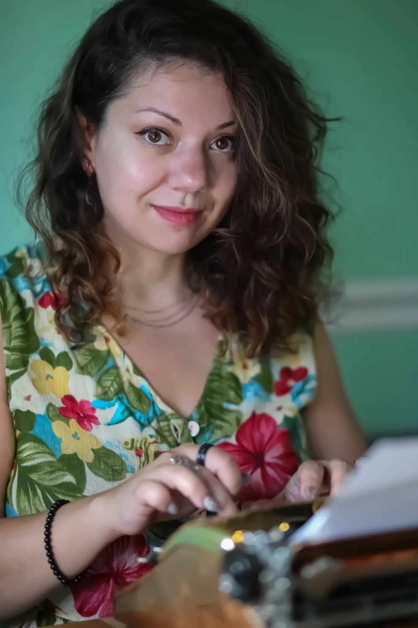 Nika Murphy, a Ukrainian-born writer of speculative fiction smiles as she types on a typewriter.