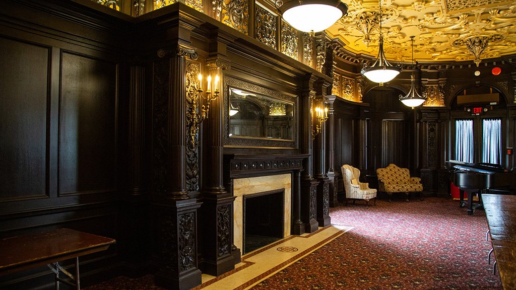 Castle Dining Room - The walnut cabinetry and plaster friezes in the Library and the columns and caryatids and strapwork ceiling in the Dining room are inspired by interiors of the Château de Fontainebleau.