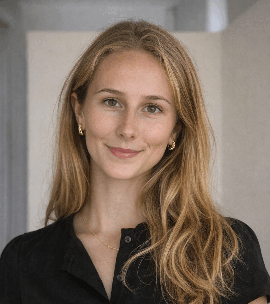 Headshot of Sydney Welch: dirty blonde hair, black top, and a closed lip smile