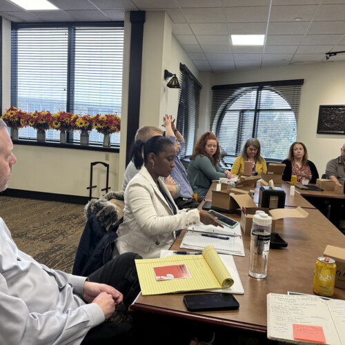 Professors sitting around a table discussing PTR.