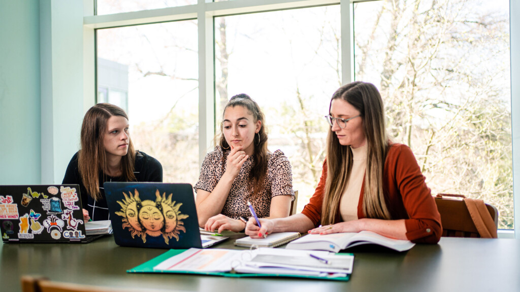 Three students studying in the library together