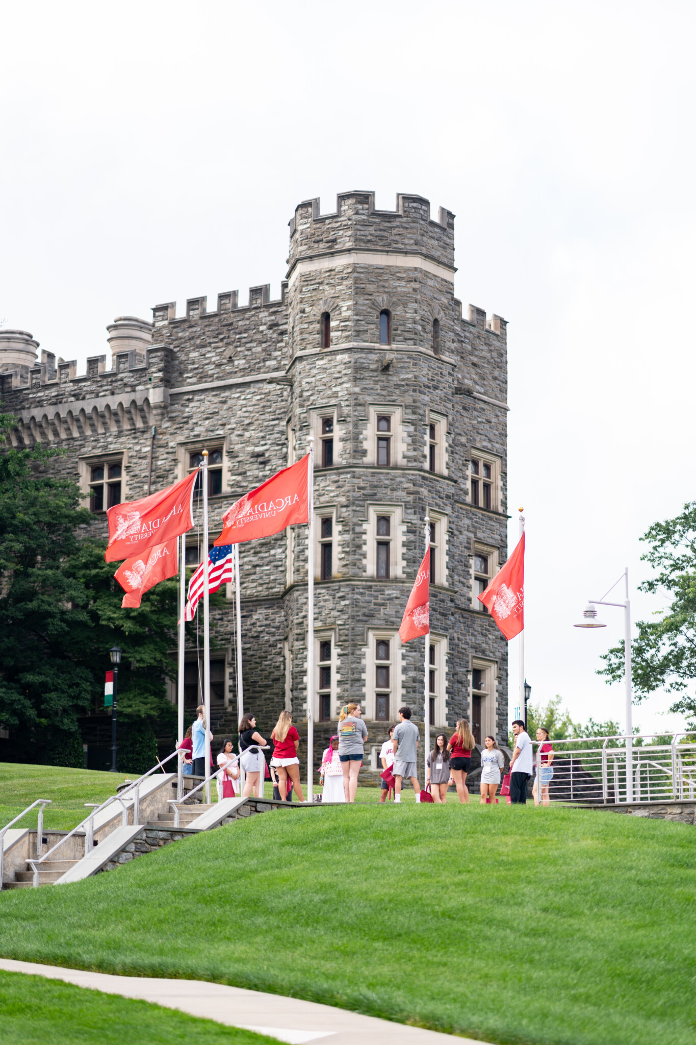 A group of undergraduate students walk by the castle at Arcadia.