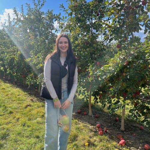 Santina Kobierecki ’25 in an apple orchard.