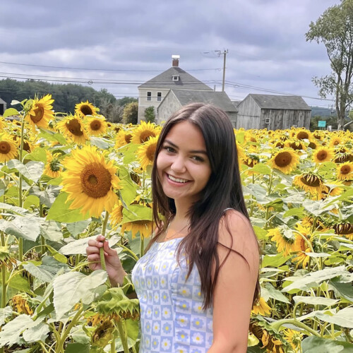 Nicole Burgon ’25 in a sunflower field.
